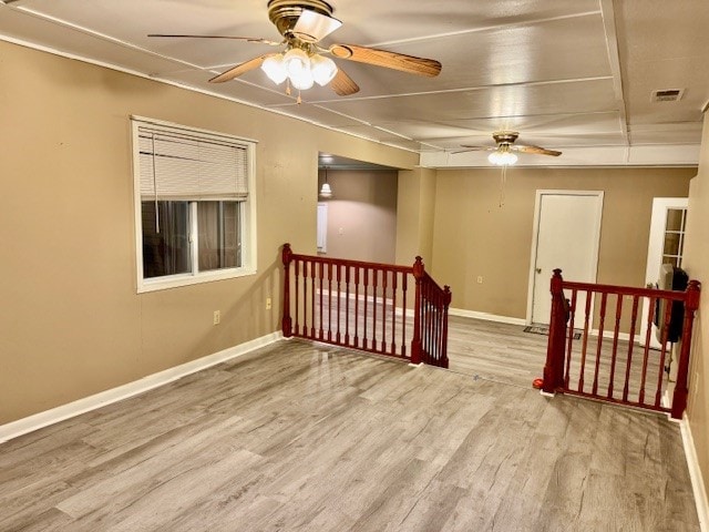 spare room featuring hardwood / wood-style floors and ceiling fan