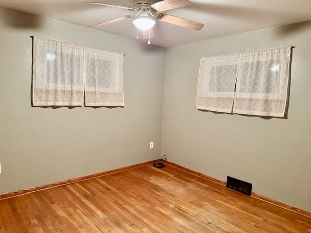 spare room with ceiling fan and light hardwood / wood-style floors