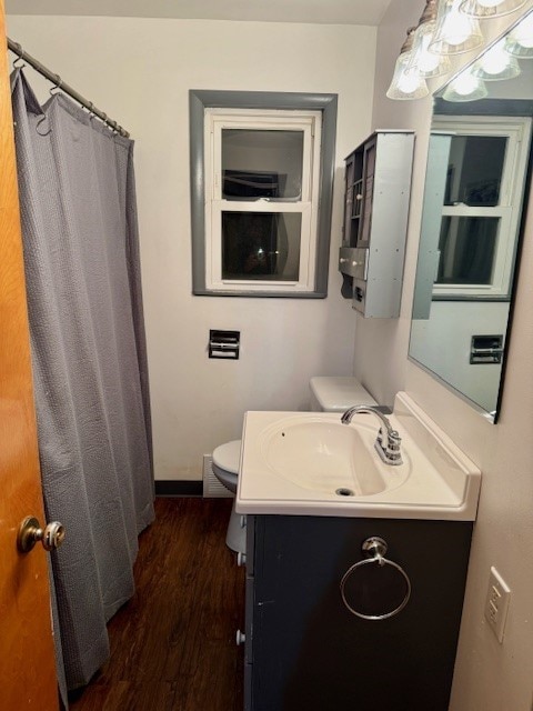 bathroom with hardwood / wood-style floors, vanity, toilet, and a shower with shower curtain