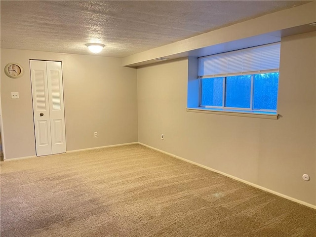 empty room featuring carpet flooring and a textured ceiling