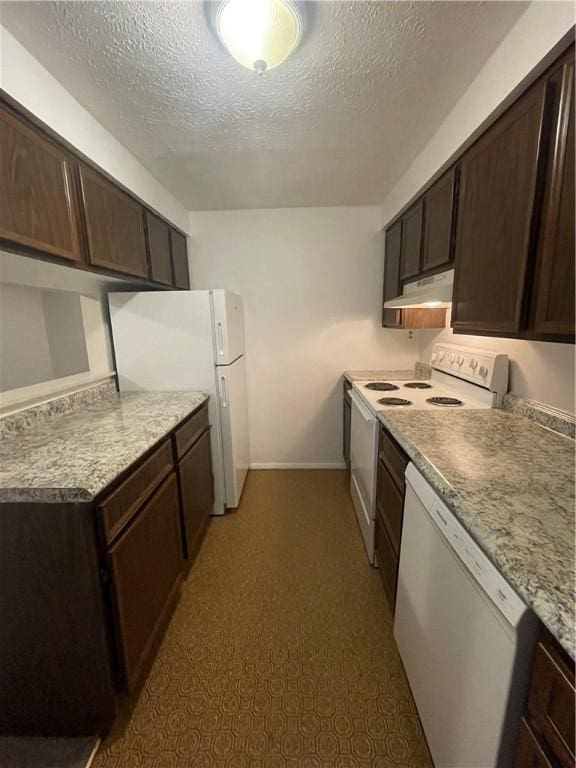 kitchen featuring dark brown cabinets, white appliances, and a textured ceiling