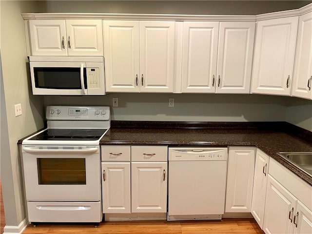 kitchen with light wood-type flooring, white appliances, white cabinetry, and sink