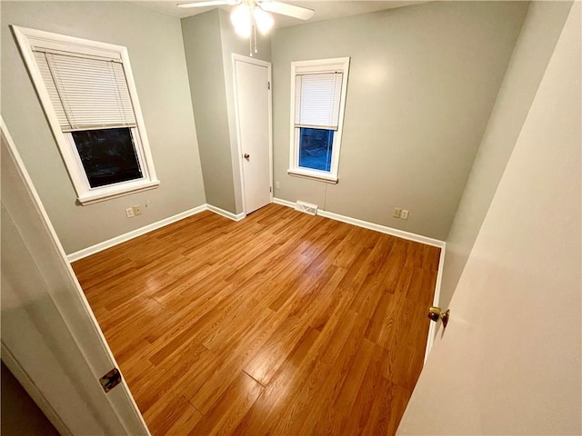 empty room with light hardwood / wood-style floors and ceiling fan