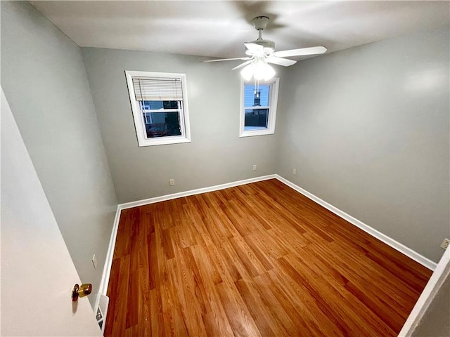 unfurnished room with ceiling fan and wood-type flooring