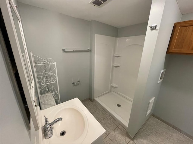 bathroom featuring a shower and sink