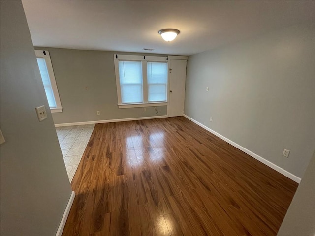 spare room featuring wood-type flooring