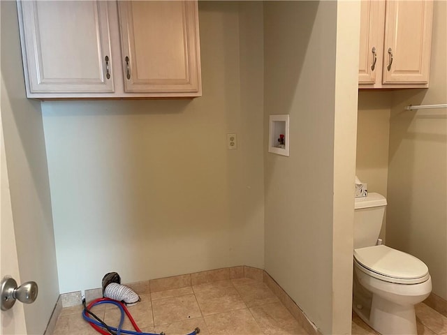 washroom with hookup for a washing machine and light tile patterned flooring