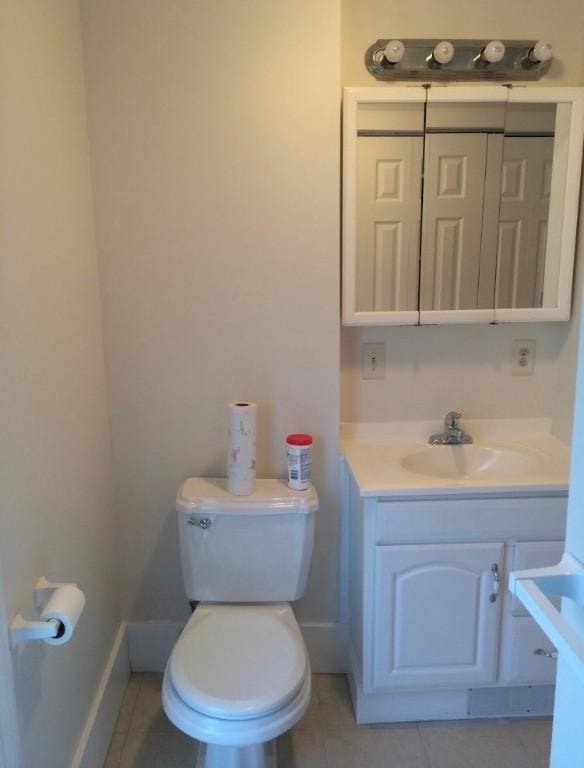 bathroom featuring tile patterned floors, vanity, and toilet