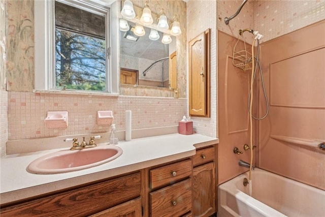 bathroom featuring backsplash, vanity, and bathtub / shower combination