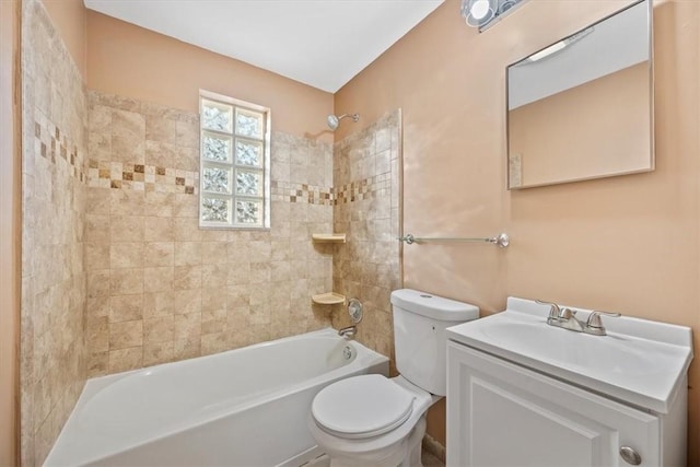 full bathroom with vanity, tiled shower / bath combo, and toilet