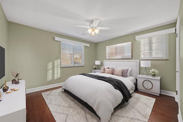 bedroom with ceiling fan and dark wood-type flooring