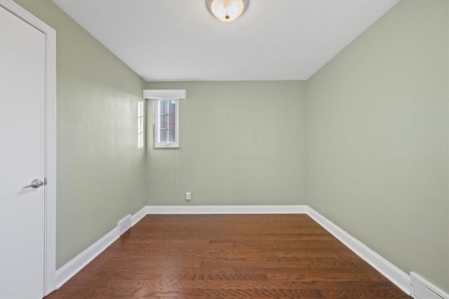 empty room with dark hardwood / wood-style floors