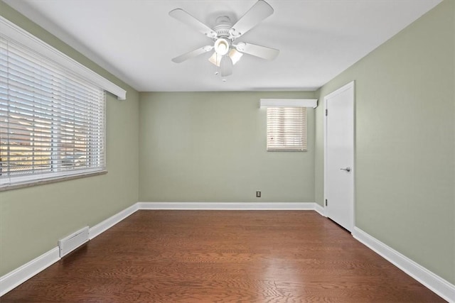 unfurnished room with dark hardwood / wood-style floors, ceiling fan, and a wealth of natural light