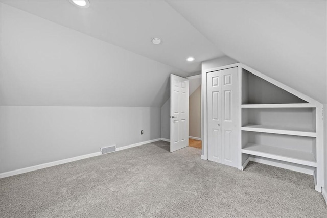 bonus room featuring carpet flooring and vaulted ceiling