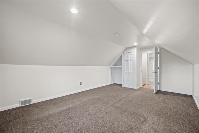 bonus room with carpet flooring and lofted ceiling