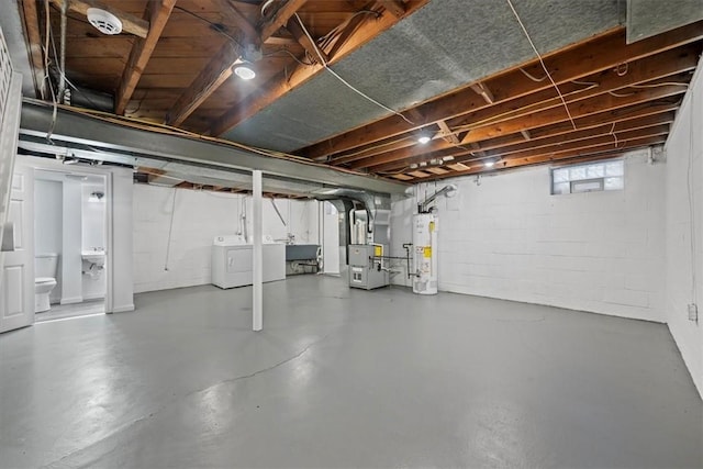 basement with washer and dryer, sink, heating unit, and water heater