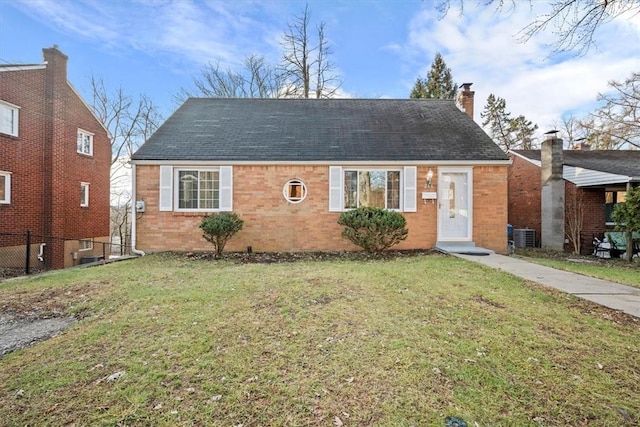 bungalow-style house featuring a front lawn