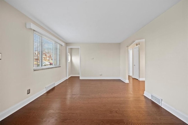 spare room with dark hardwood / wood-style floors