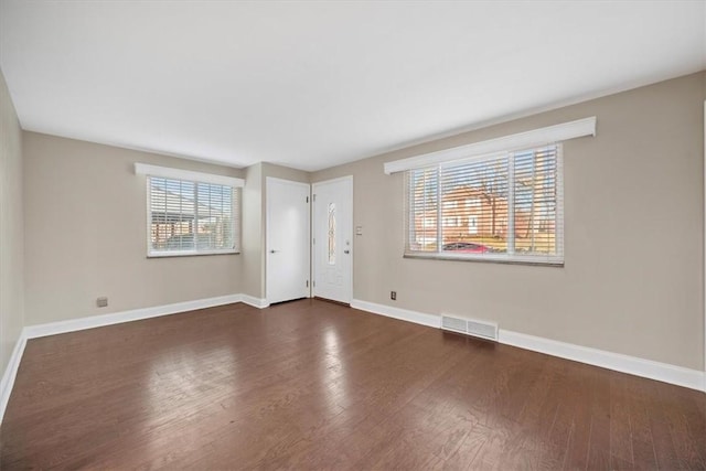 unfurnished room with dark hardwood / wood-style flooring