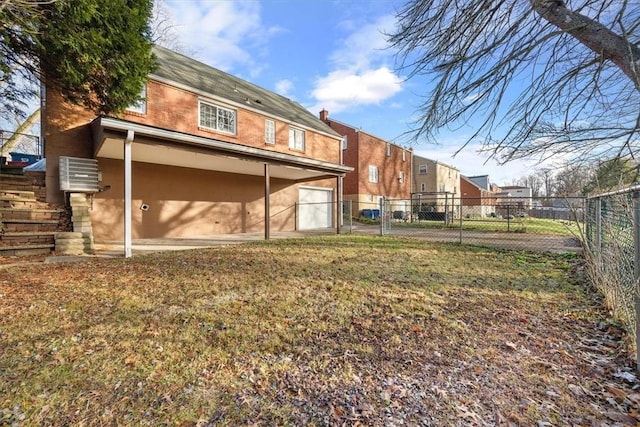 rear view of property featuring a lawn