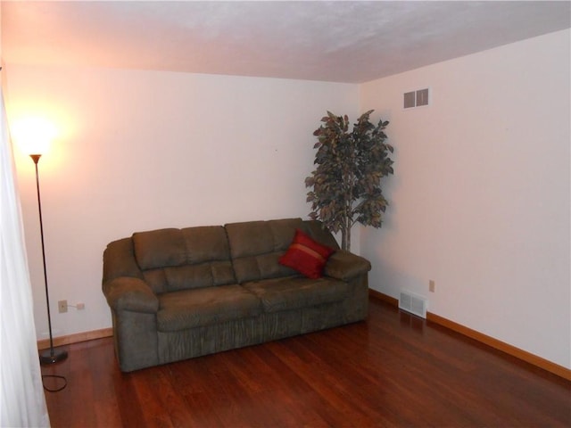 living room with dark hardwood / wood-style flooring