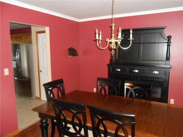 dining room featuring ornamental molding and a notable chandelier