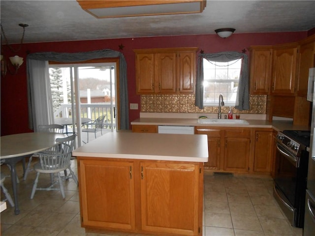 kitchen featuring light tile patterned flooring, stainless steel range with electric cooktop, backsplash, sink, and a kitchen island