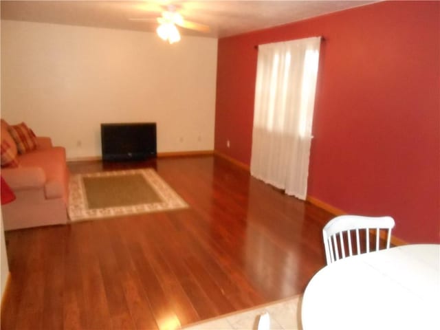 living room with hardwood / wood-style floors and ceiling fan