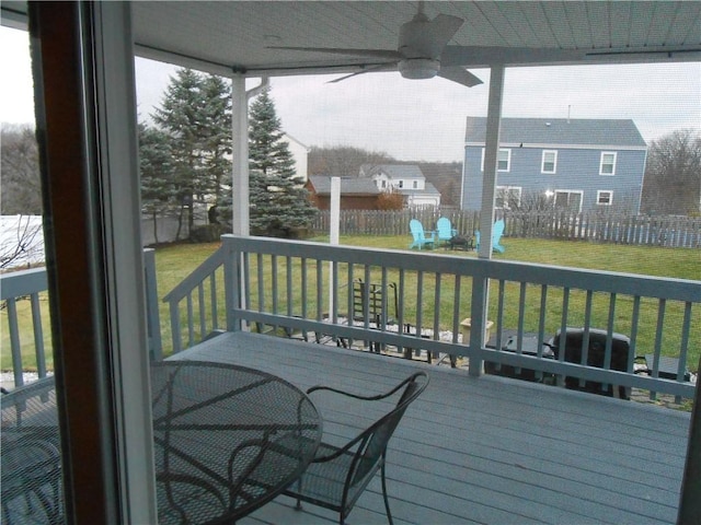 wooden deck featuring a yard and ceiling fan