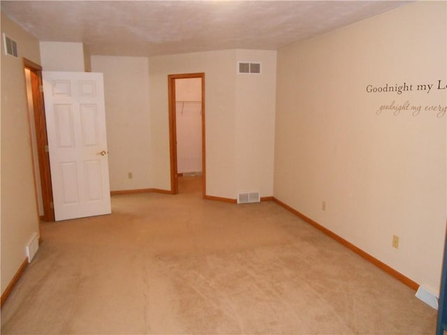 unfurnished room with light carpet