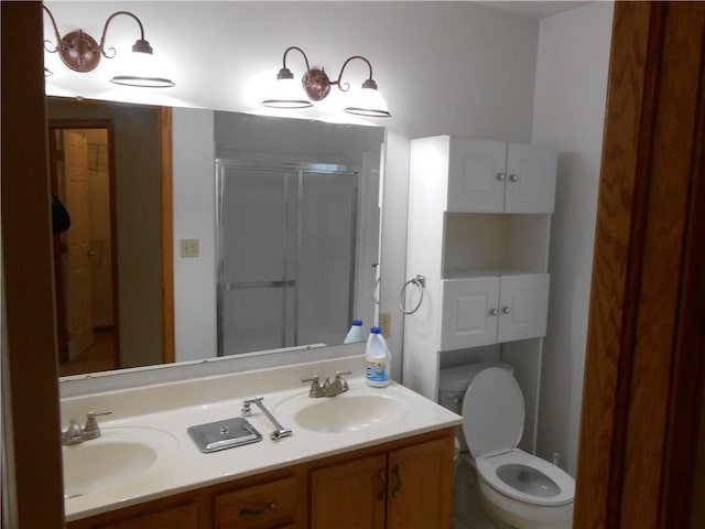 bathroom featuring vanity, toilet, and walk in shower