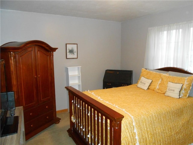 bedroom featuring light colored carpet