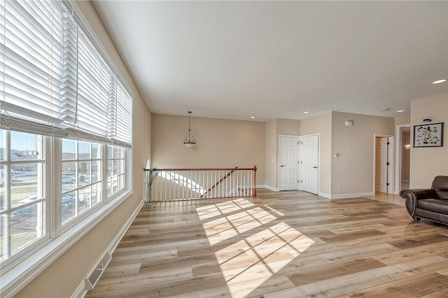 unfurnished room with light hardwood / wood-style floors