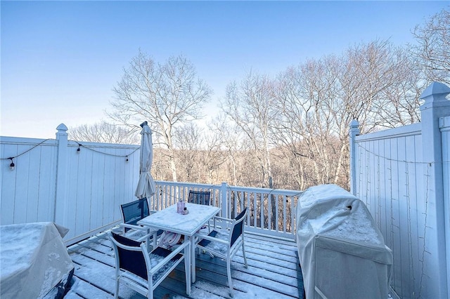 wooden deck featuring a grill