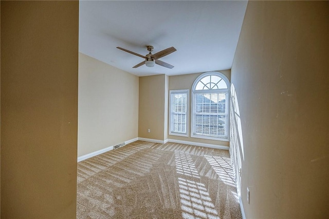 carpeted empty room with ceiling fan