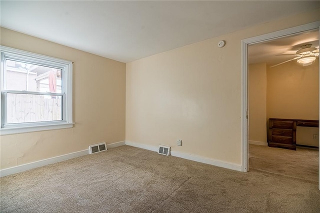 empty room featuring carpet floors and ceiling fan