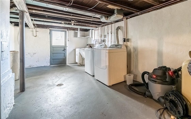 basement featuring washing machine and clothes dryer and sink