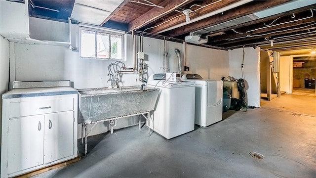 basement with separate washer and dryer and sink