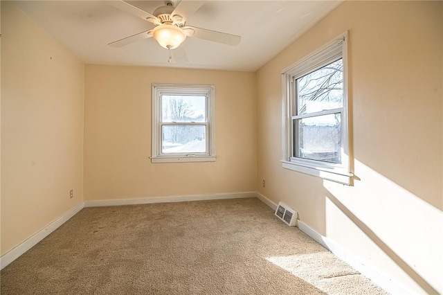 carpeted empty room featuring ceiling fan