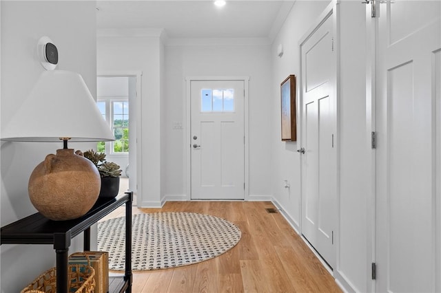 entrance foyer with crown molding and light wood-type flooring