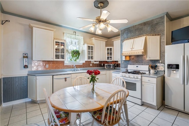 kitchen with custom range hood, sink, white appliances, and ornamental molding