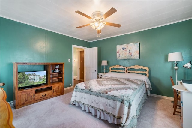 carpeted bedroom with ceiling fan and crown molding