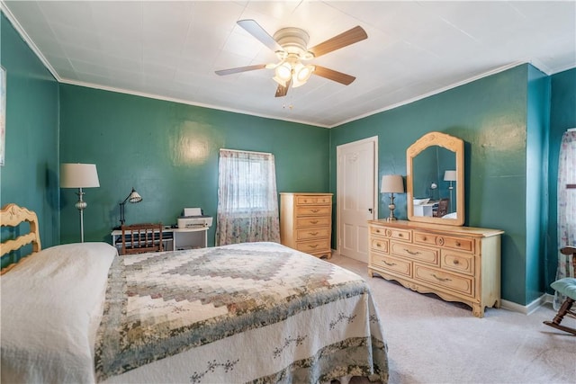 carpeted bedroom featuring ceiling fan and ornamental molding