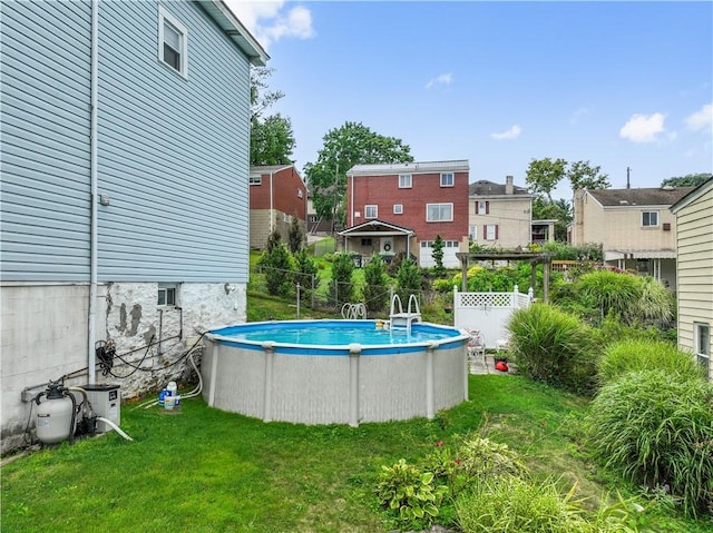 view of pool with a yard