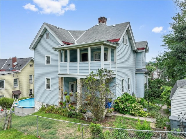 rear view of house featuring a balcony