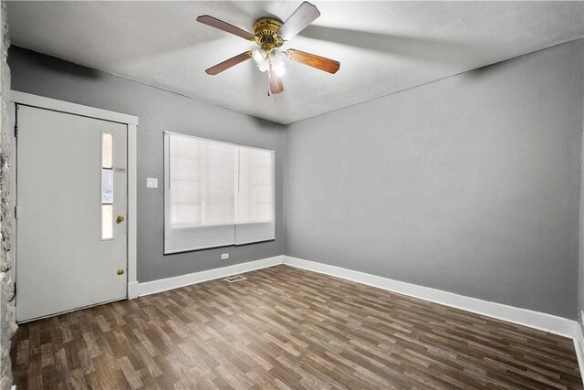 foyer entrance with ceiling fan and dark wood-type flooring