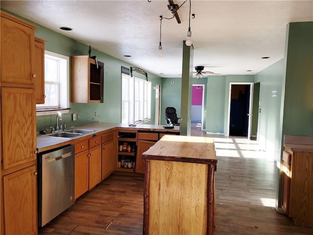 kitchen with dark hardwood / wood-style flooring, ceiling fan, sink, dishwasher, and a center island