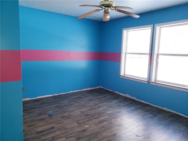 empty room with dark hardwood / wood-style flooring and ceiling fan