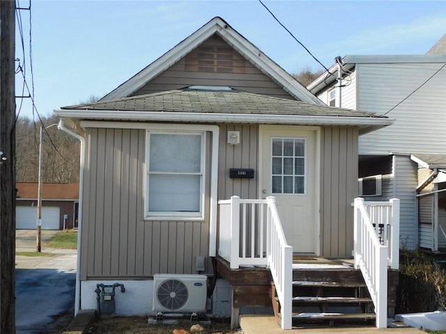 bungalow-style house with ac unit