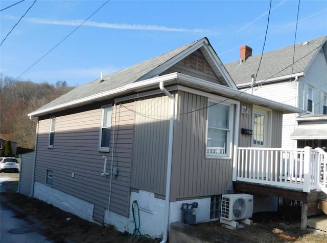 view of side of home with ac unit